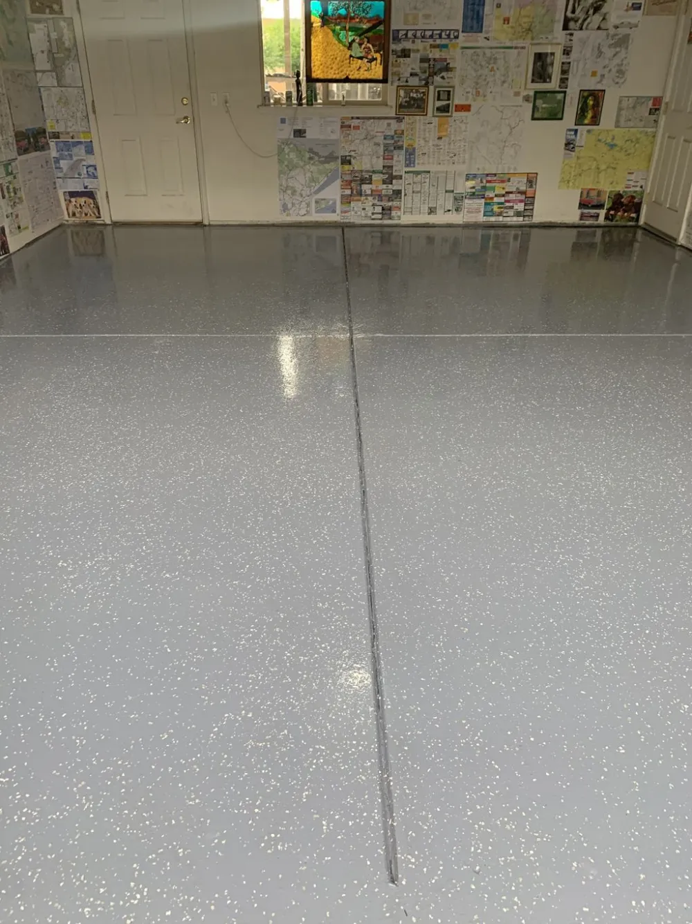 Gray flake garage floor coating with a sealed control joint in a Denver garage