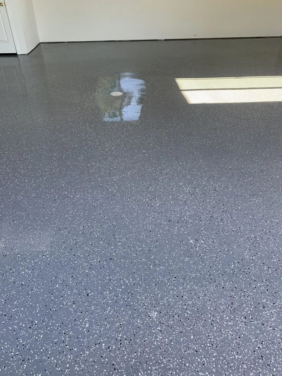 Full-broadcast flake floor coating reflecting window light